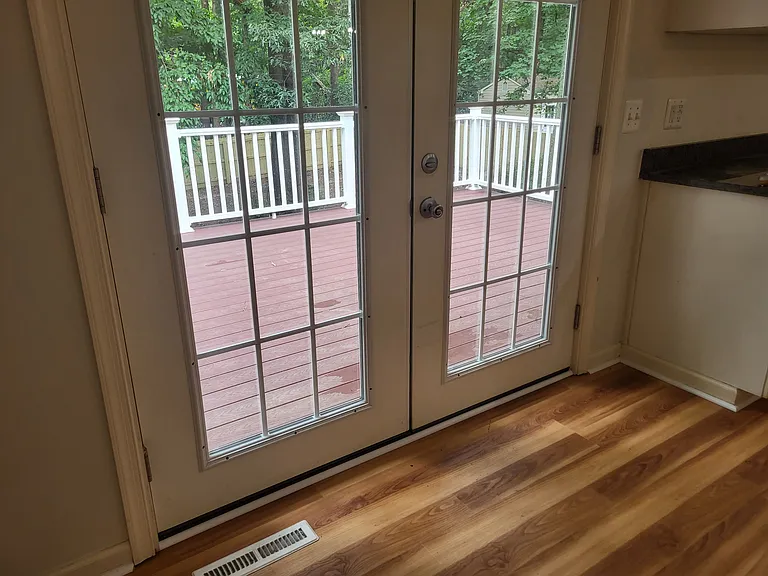 view from kitchen/dining area doors to large back deck