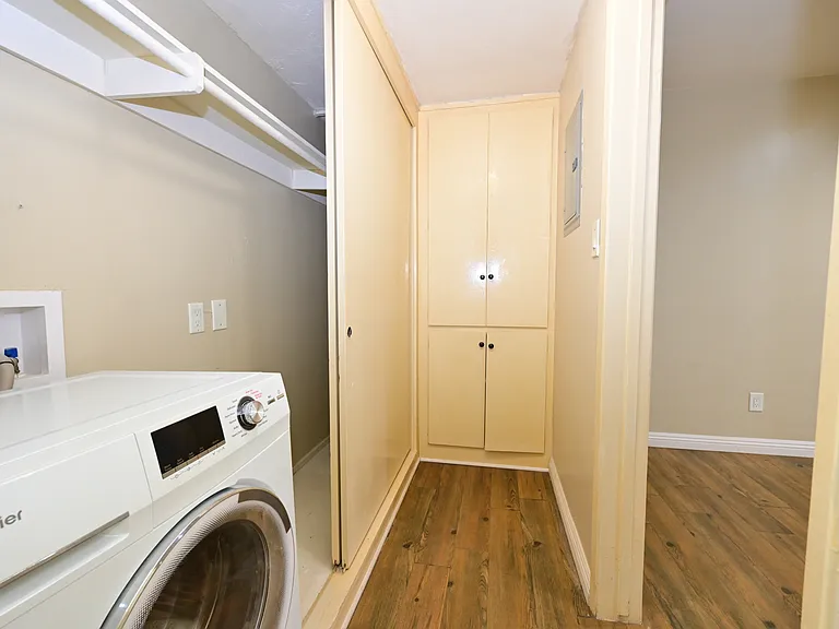 in-unit all-in-one laundry machine with plenty of storage cabinet