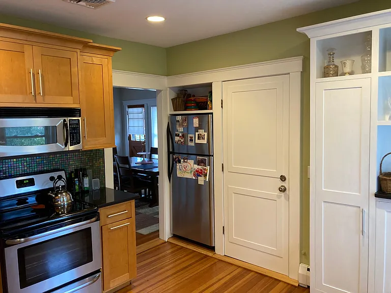 Kitchen (with stove and refrigerator) looking into dining room