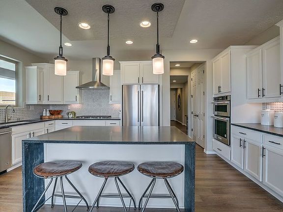 The Ocotillo kitchen with our Chef package that includes staggered cabinetry and built-in appliances