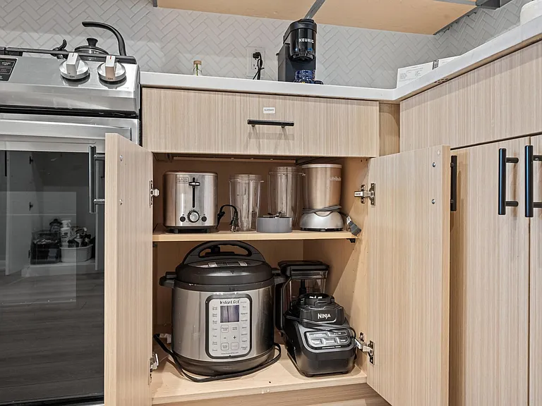 The kitchen is fully stocked with all dishes, utensils, and appliances including this Insta Pot, Ninja Blender, Nutri Bullet, toaster, Keurig, and stovetop kettle. There is also a Sonos speaker, automatic refilling filtered water pitcher, and more!