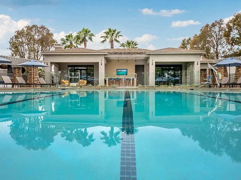 Resort-Style Pool at Camino Real Apartments with Clubhouse and Lounge Chairs