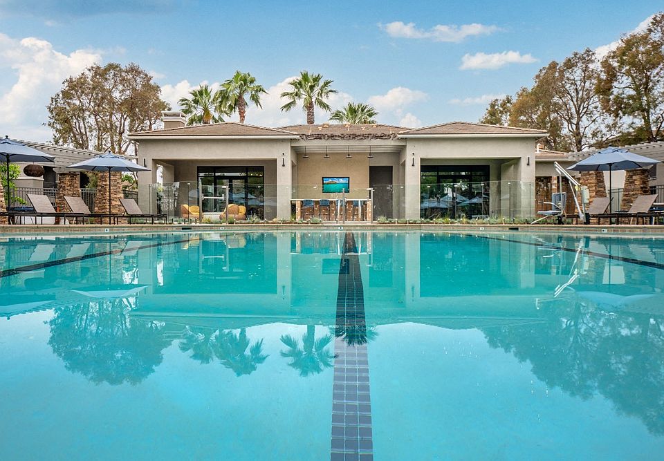 Resort-Style Pool at Camino Real Apartments with Clubhouse and Lounge Chairs