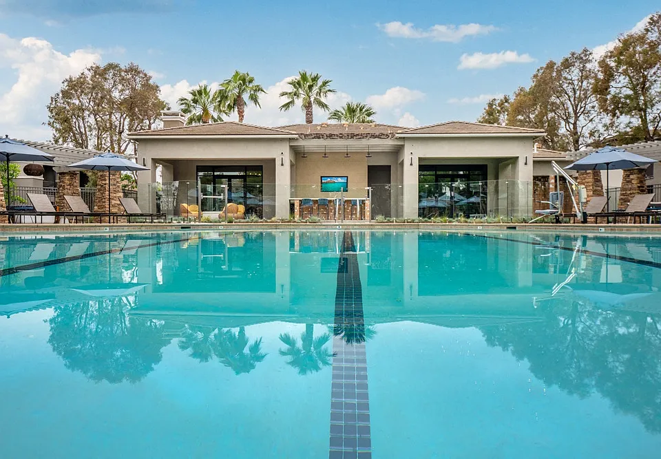 Resort-Style Pool at Camino Real Apartments with Clubhouse and Lounge Chairs