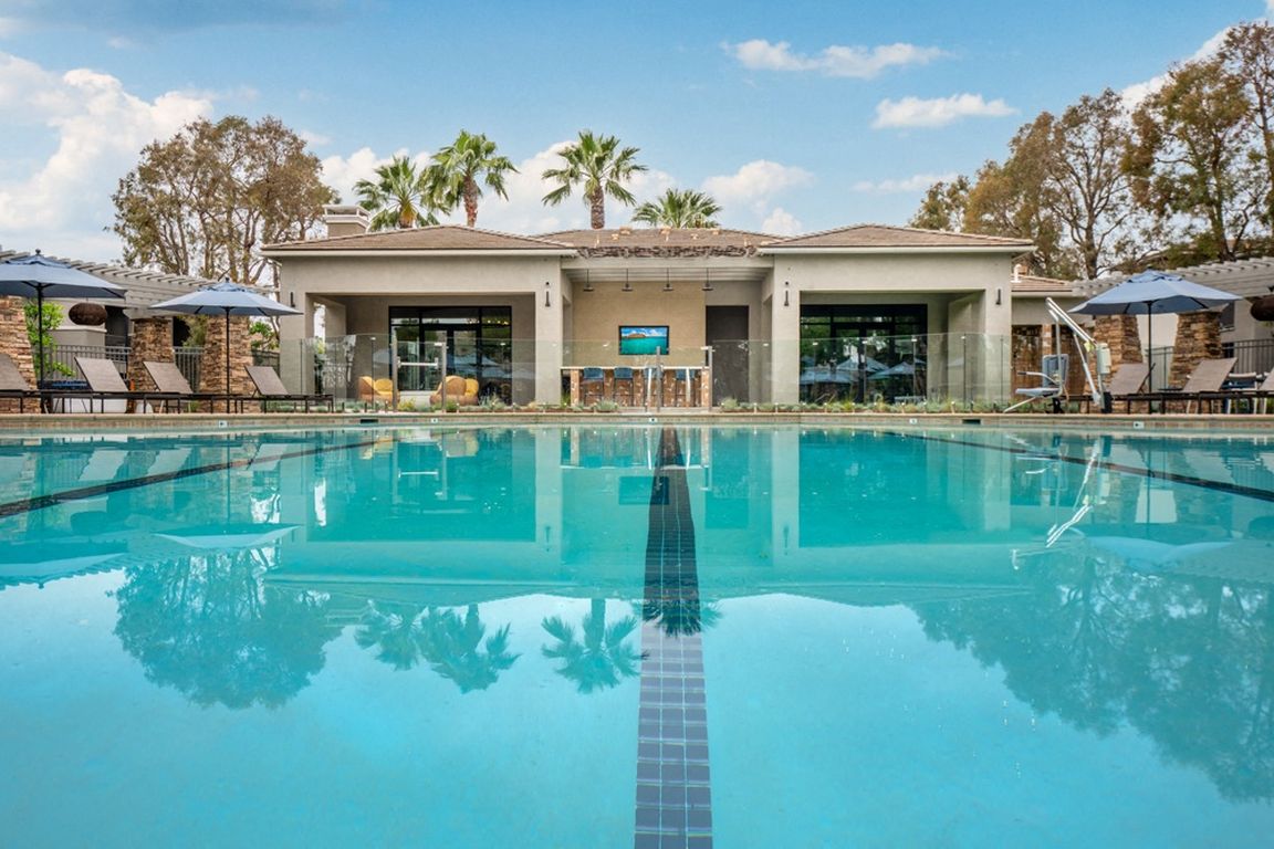 Resort-Style Pool at Camino Real Apartments with Clubhouse and Lounge Chairs