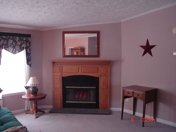 FAMILY ROOM WITH FIREPLACE OPEN TO VIEW OF KITCHEN & SEP LIVING ROOM
