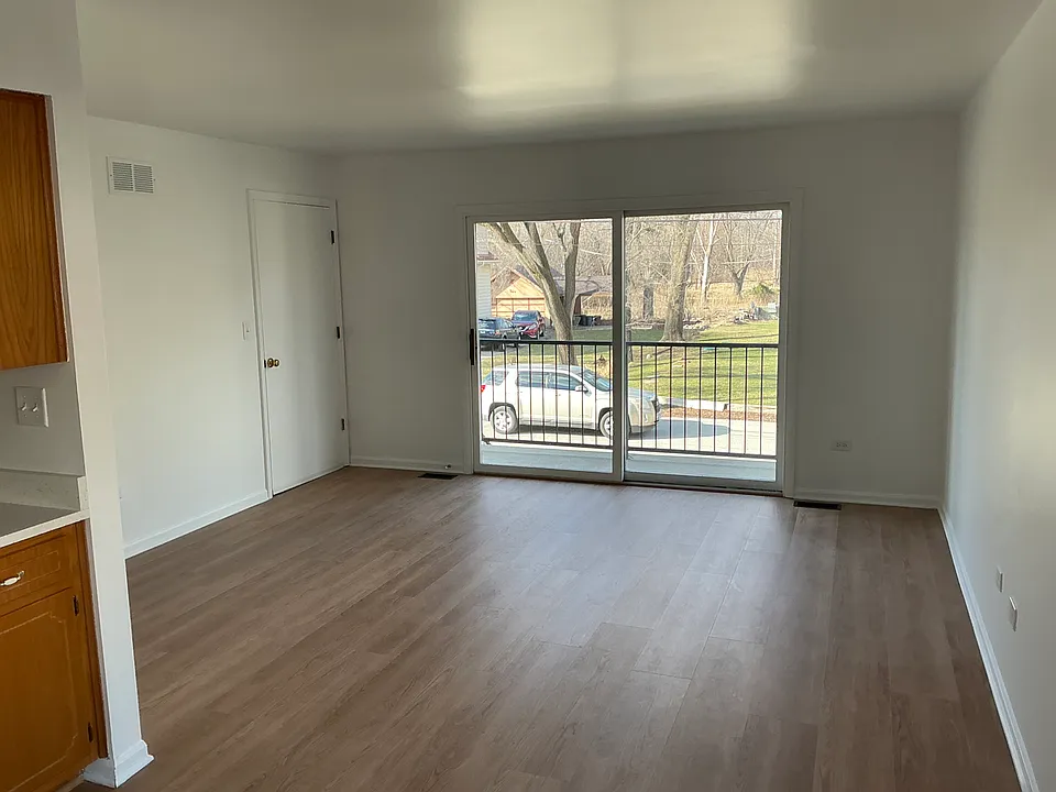 Living room off the kitchen facing the forest preserves and walkout balcony. Room dimensions 13 x 14.
