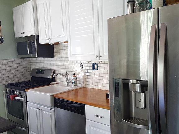 Farmhouse sink kitchen with French country seating island
