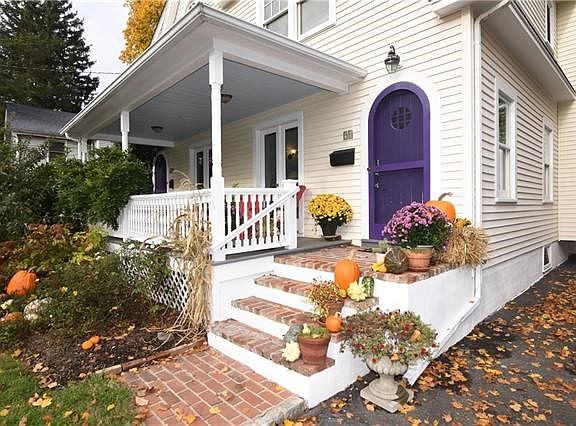 Brick walkway leads to the wood floor covered porch.