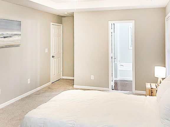 Trey ceiling with ceiling fan and private full bathroom