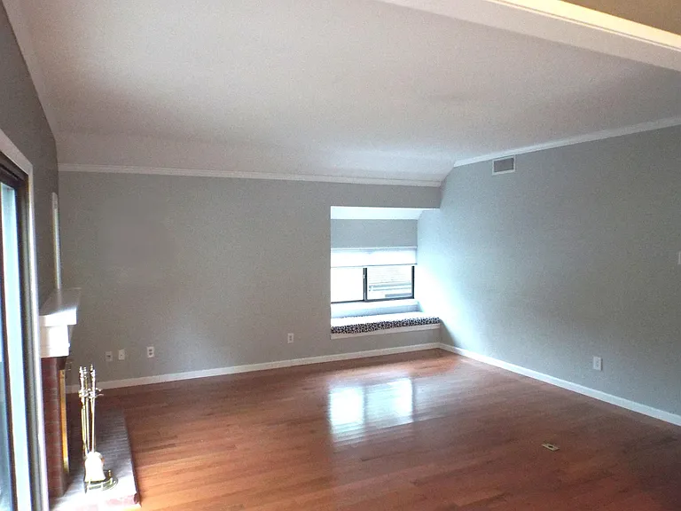 Bright Sunny window seat in the living room. Hardwood Floors throughout the unit.