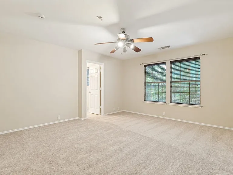Upstairs rear facing primary bedroom overlooking trees.
