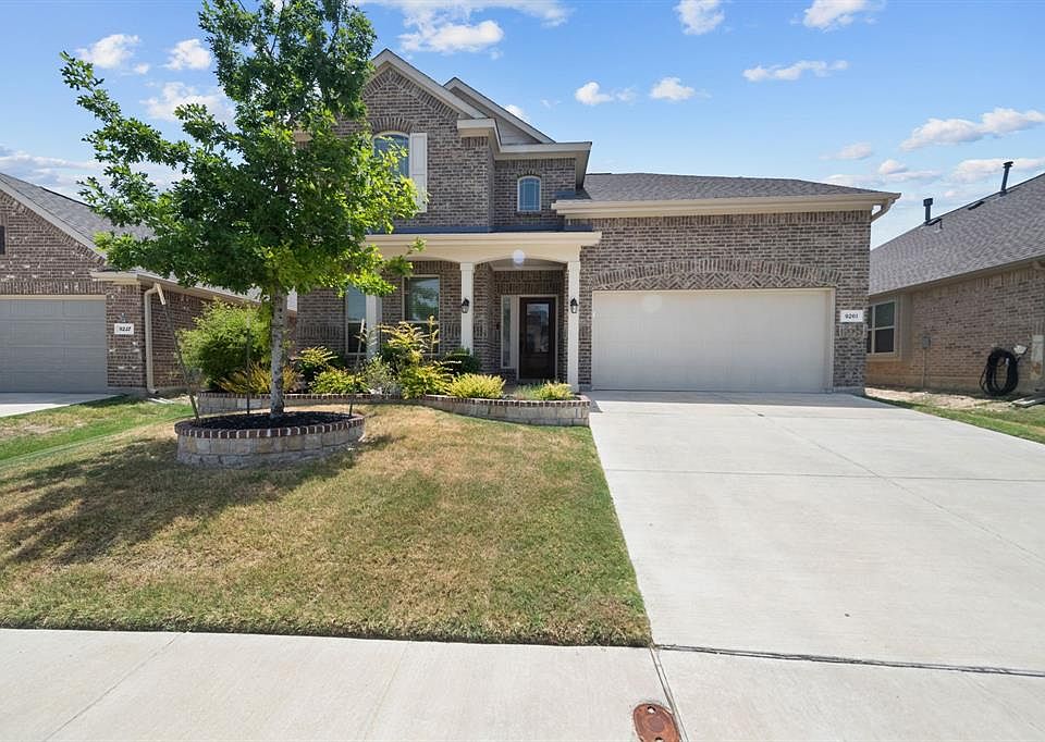 View of front of property with a garage and a front yard