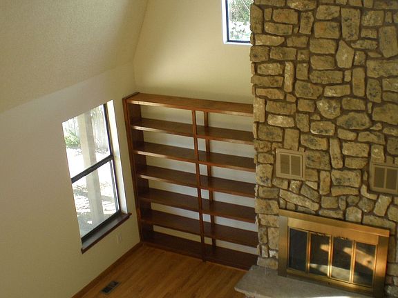 2-Story Stone Fireplace and Built-In Bookshelves