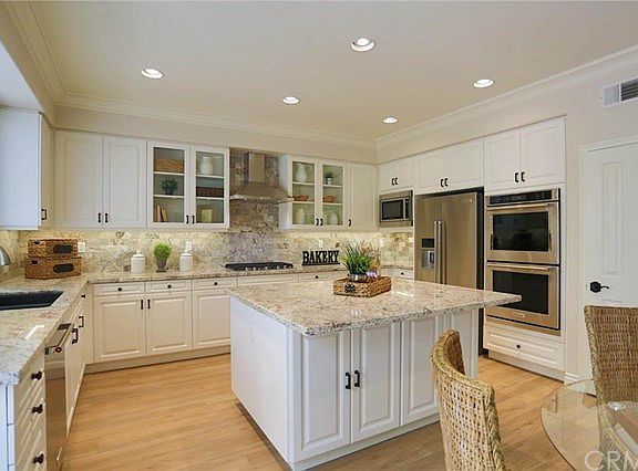 This angle of the kitchen shows the walk-in pantry, the double ovens and microwave as well as the 5 
