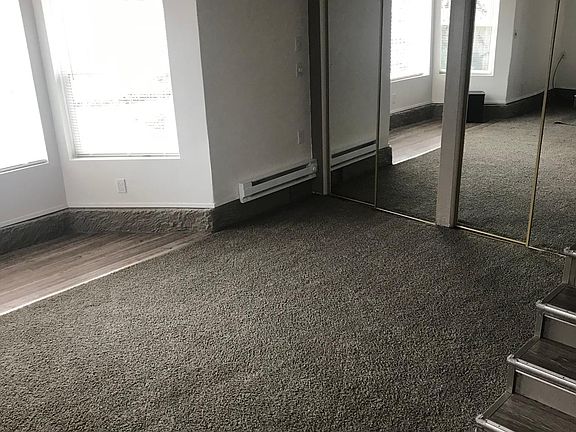 Living room closet and 3 steps up to kitchen