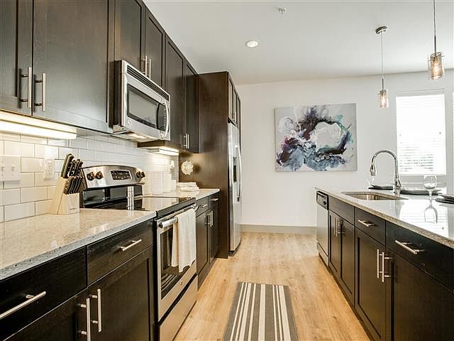 Large Eat In Kitchen with subway tile back splash.