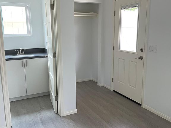 Full bath, hanging closet and door to outside