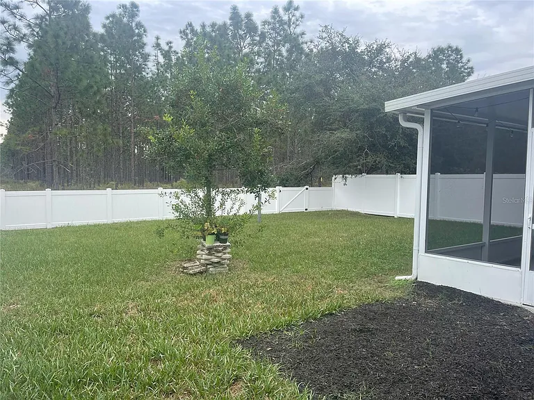 Fully fenced in yard overlooking conservation.