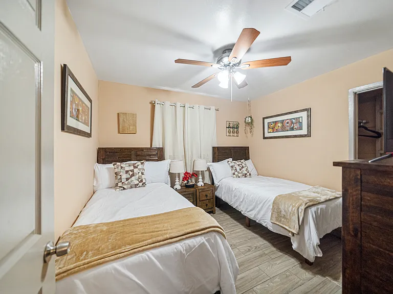 Bedroom with 2 twin beds, dresser and 32" TV