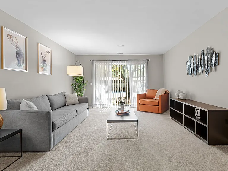 Spacious Living Room with Sliding Glass Door at Lakeside Village Apartments Clinton Township MI