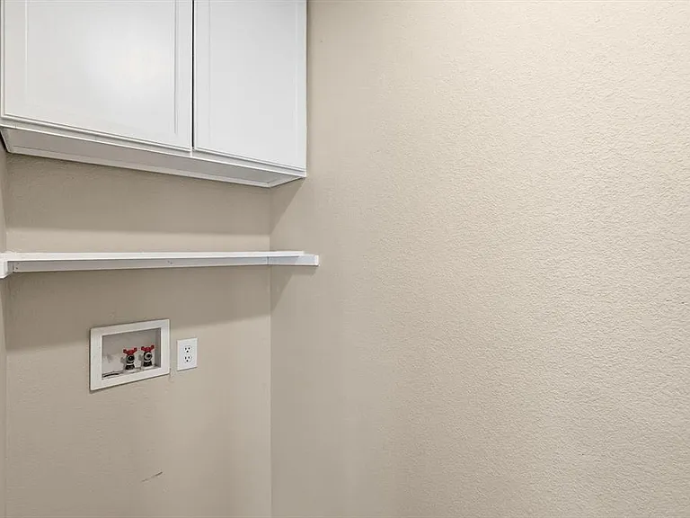 Laundry area with cabinet space and washer hookup