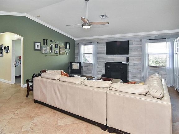 Family room with cathedral ceilings and accent wall.