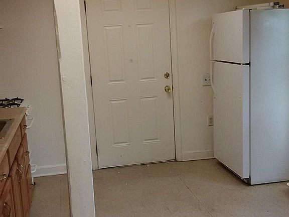 Kitchen refrigerator as seen through the living room "pass through"