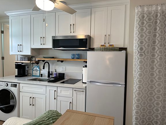 This kitchen has all the necessary utensils: cooktop, microwave, washer/dryer, refrigerator, nutribullet, coffee maker, cooking utensils, silverware, glassware, pans, pots, cleaning supplies.