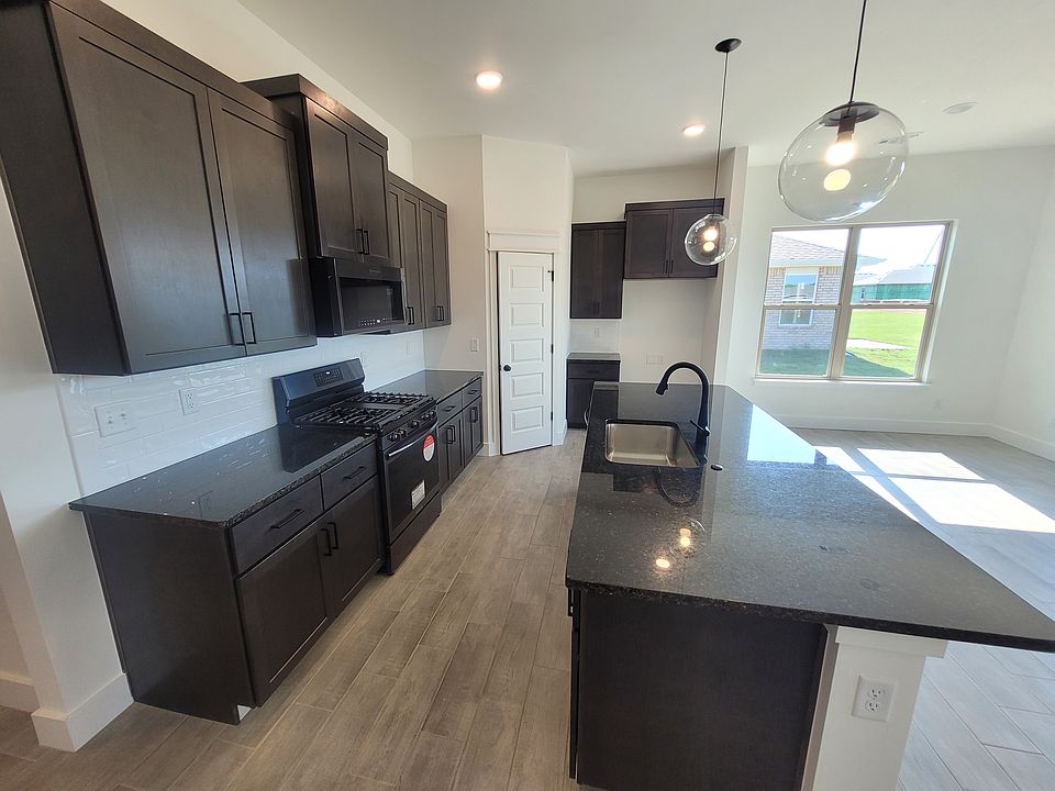 Gas stove with dark brush steel appliances