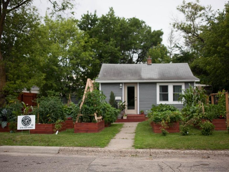 Front of the house with raised garden beds