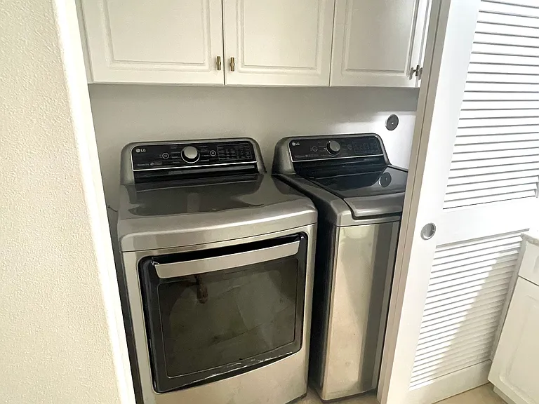 Washer and dryer located in guest bathroom