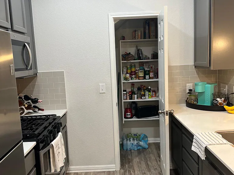 Walk in pantry with wrap around storage to left of pictured opening.