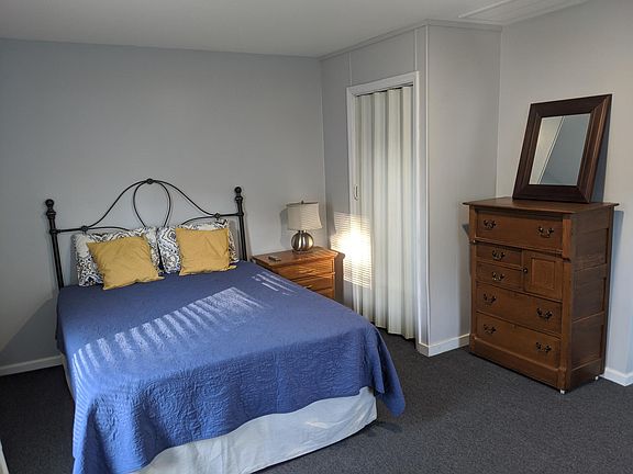 At top of the stairs is a hallway connecting the bedroom, shown here with closet, and living room.