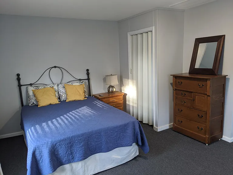 At top of the stairs is a hallway connecting the bedroom, shown here with closet, and living room.
