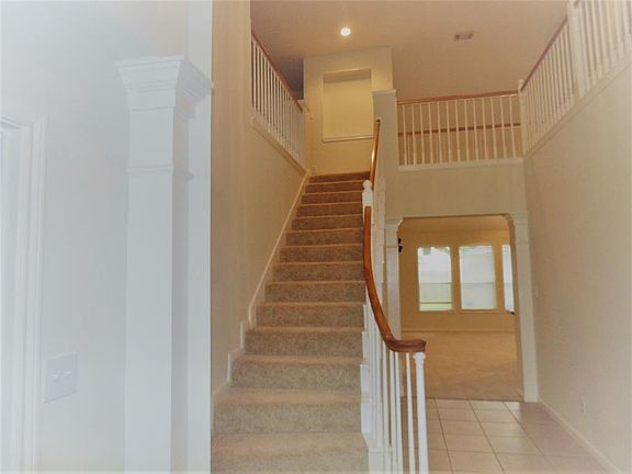 Beautiful Two Story Foyer offers a lovely spindle staircase. New Carpet was installed in June. Interior painted to a neutral color.