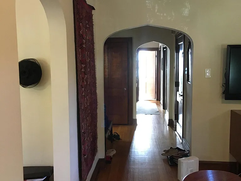 Looking down the hallway from the living room. Dining room on left. Front hall closet further down on the left. 3 bedrooms and a bathroom down the hallway.