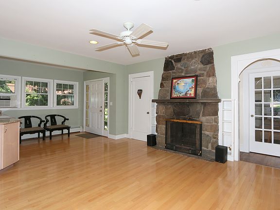 Rustic stone fireplace adds warmth and depth.
