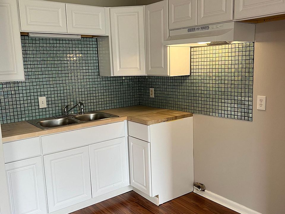 Beautiful new kitchen with glass mosaic tile and butcher block counter tops