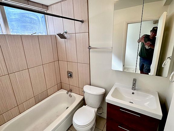 Tile, modern light and bath fixtures and updated cabinets in bath.