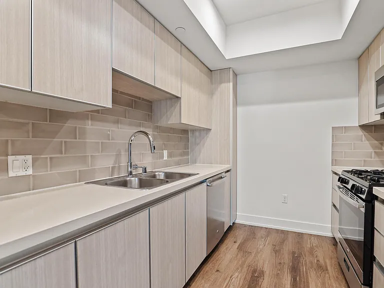 Kitchen with Double-Sink, Dishwasher, Stove, and Microwave Oven