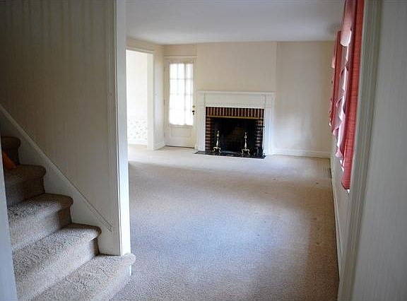 Expansive living room with adjacent screened porch