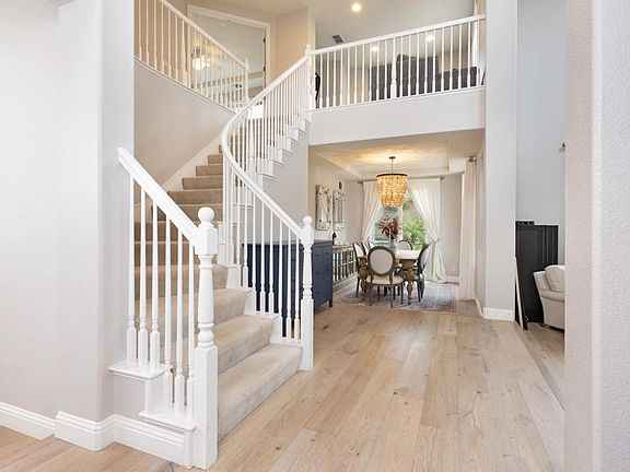 The entryway features high ceilings and an open bright floor plan