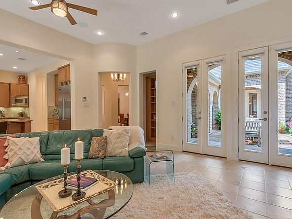 Amazing open floor plan with high ceilings and clean lines give the home a clean, modern feel. The family room opens to the kitchen and has two sets of French doors that lead to the courtyard, filling the room with natural light.