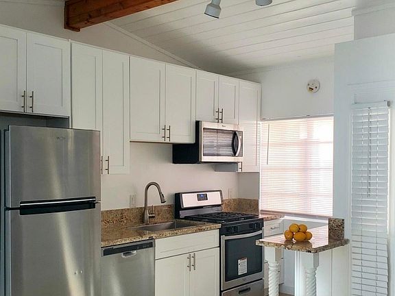 Kitchen includes Fridge, with 1 year old dishwasher, oven, stove, microwave, sink, cabinets, & granite counter tops.
