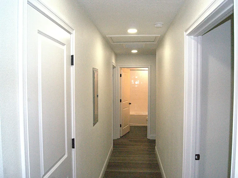 Hallway to the three bedrooms and bathroom
