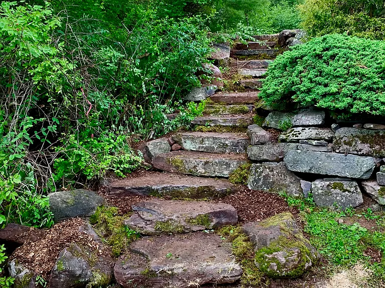 Stone steps on the left side of Grandview Cabin property leading to the open deck.