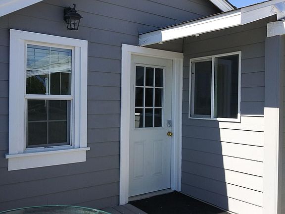 Front door to unit #3. Kitchen window on right, bedroom window on left.