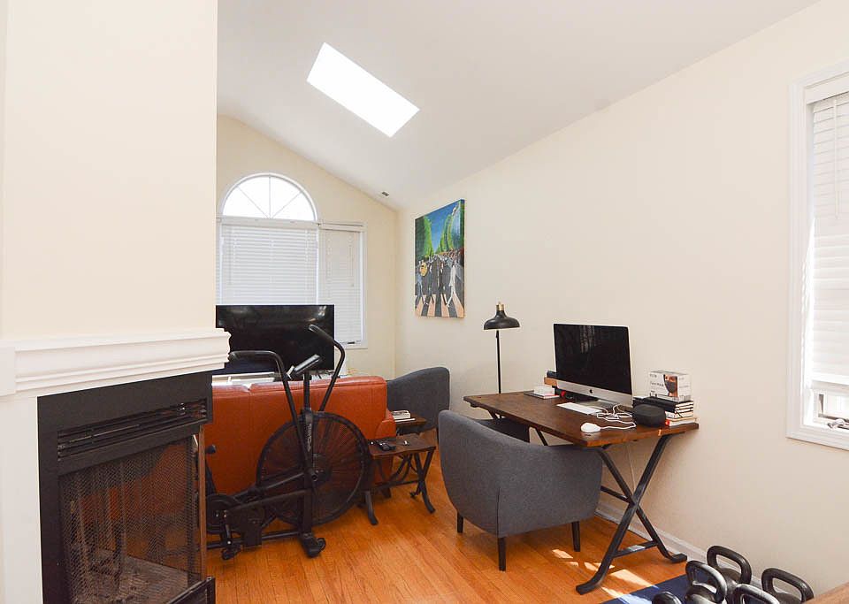 Living room has a working wood-burning fireplace with gas starter