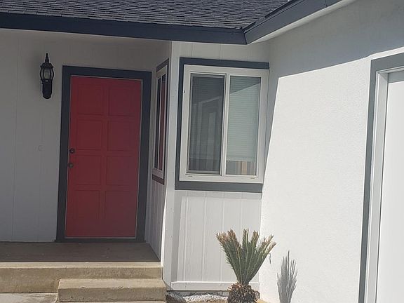 Front door and exterior side door entry to garage and interior laundry area. Laundry area may also be accessed from kitchen door into garage.
